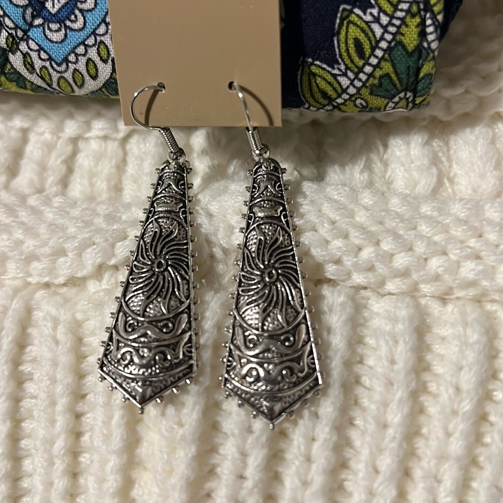 Fashion earrings. Silver tone with black accents. Hoop backing.